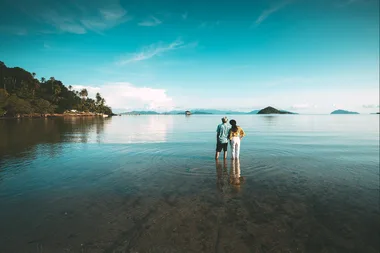 two people standing in a lake