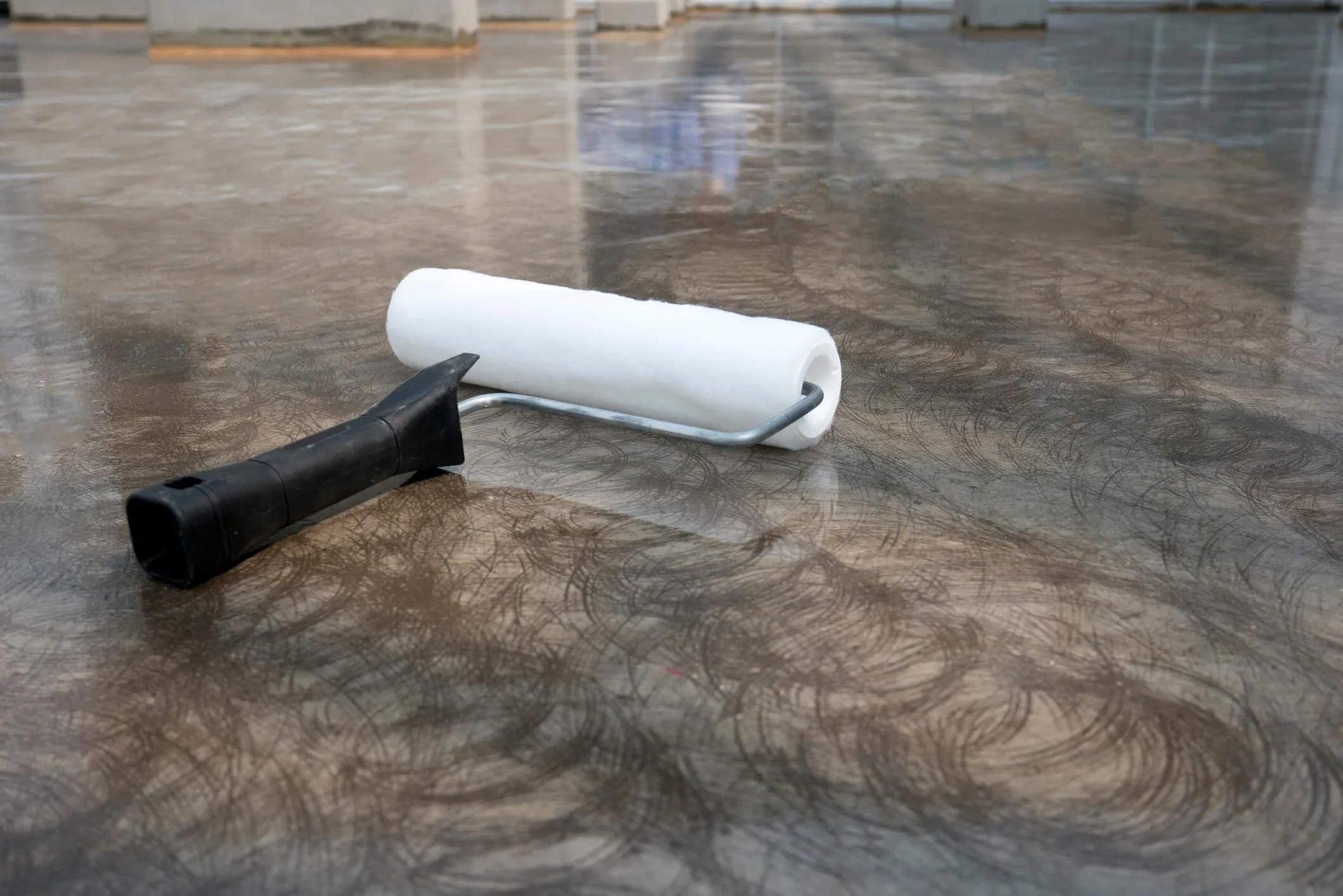 Epoxy concrete flooring with a paint roller