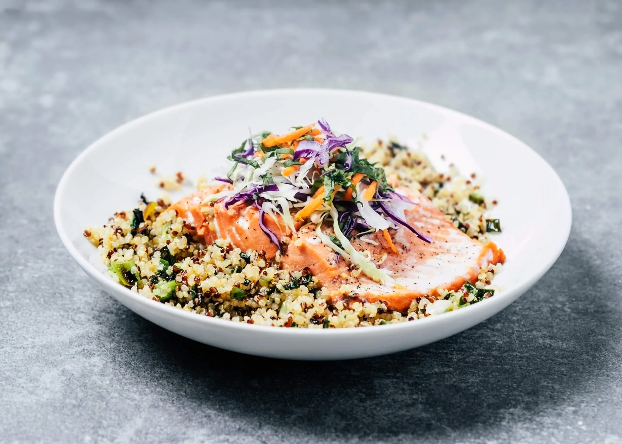 A bowl of quinoa with grilled salmon fillet