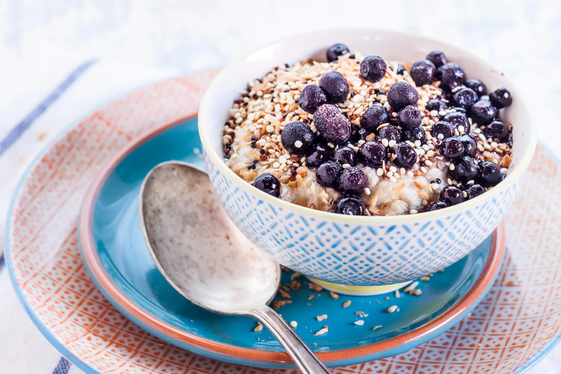 A bowl of oats with roasted quinoa and blueberries