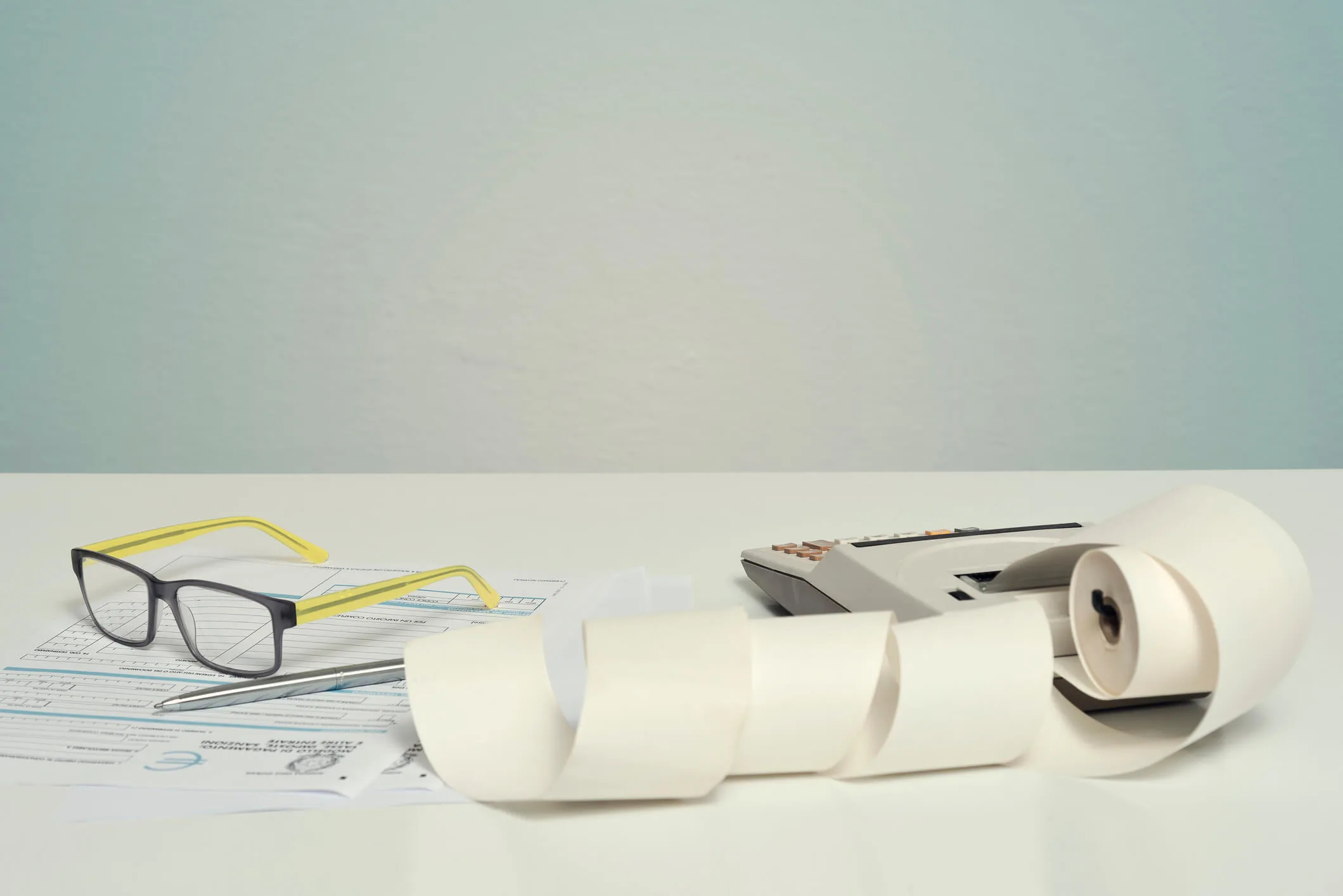 A roll of receipt paper and other accounting accessories
