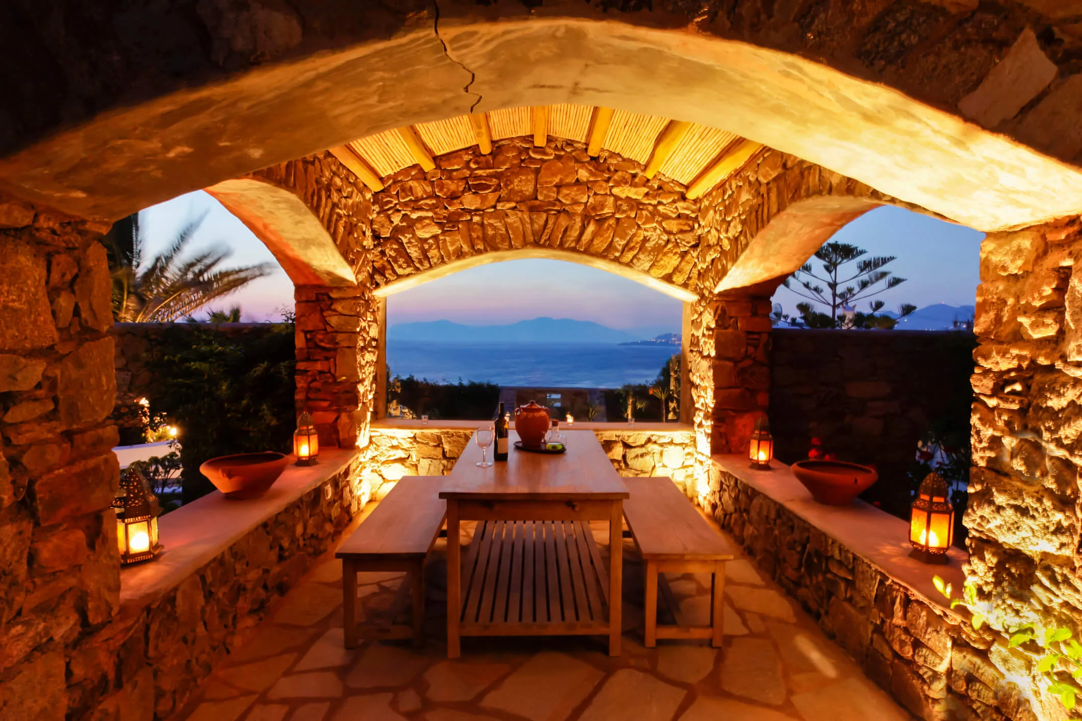 A patio lit up by garden lanterns