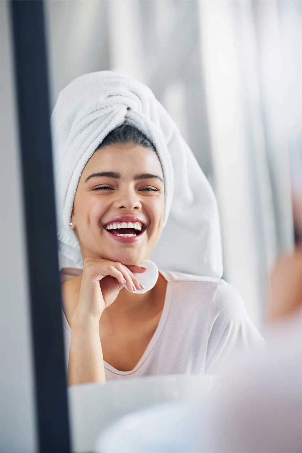 Woman smiling with towel on head