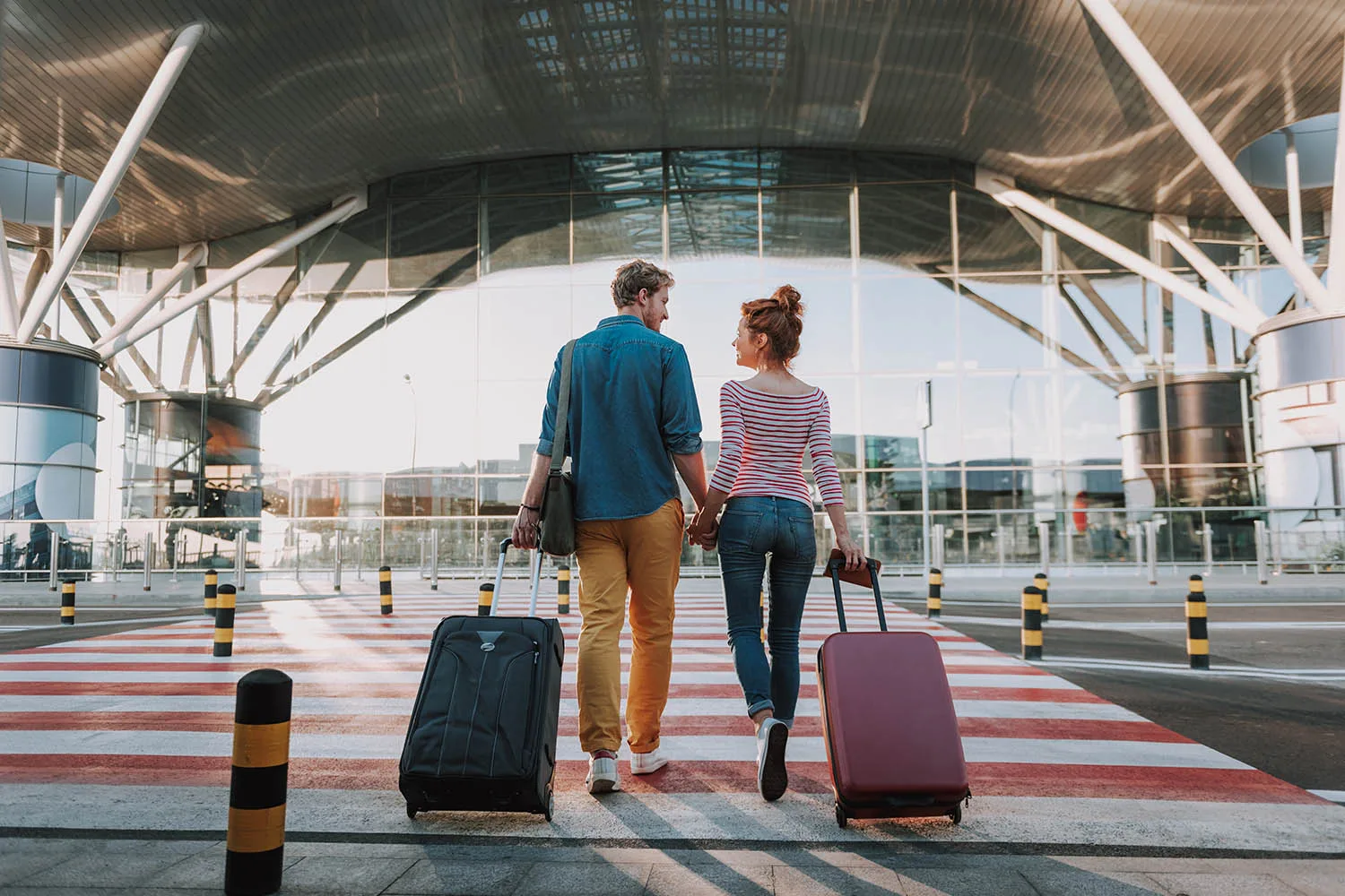 couple walking with suitcases