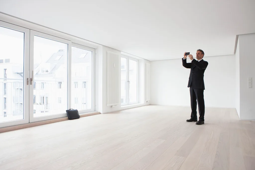 Real estate agent taking photos of house