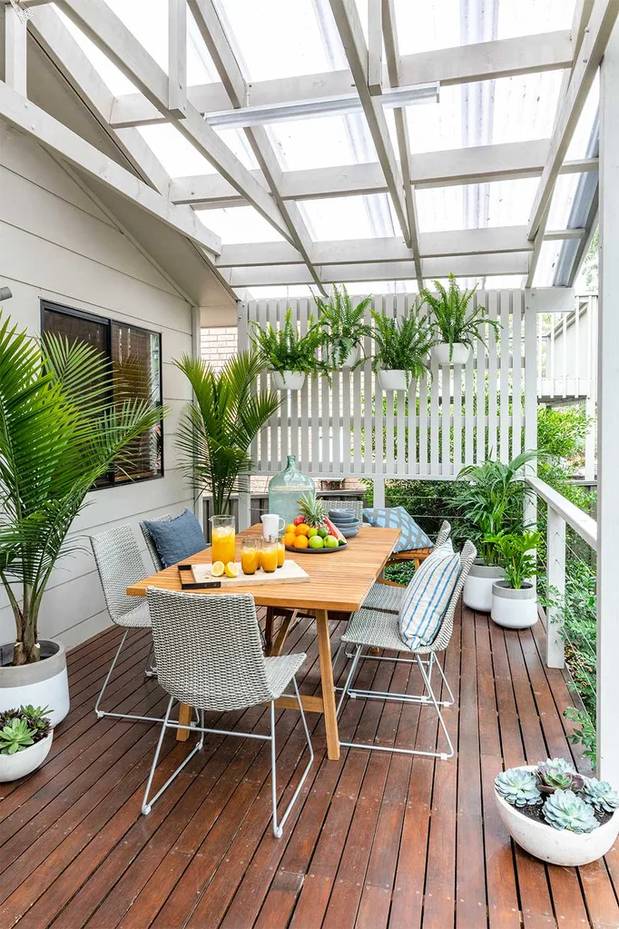 Deck with table and privacy screen with hanging plants