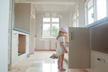 child standing in kitchen renovation