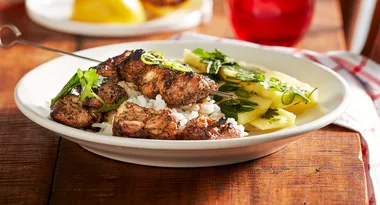 coffee and cumin chicken on skewers in bowl