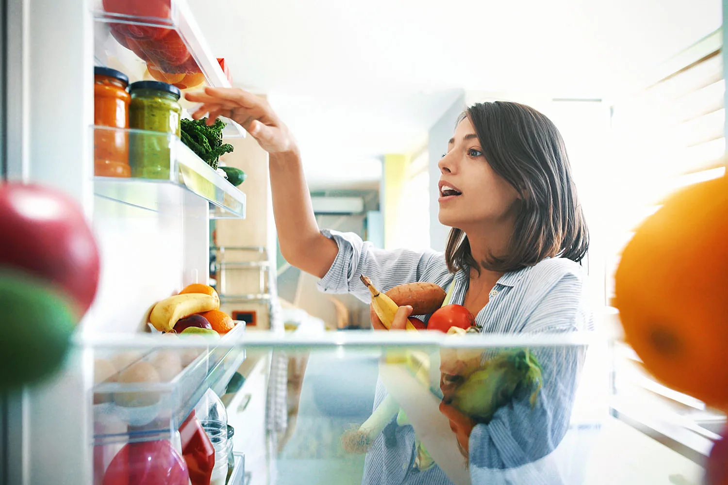 woman organising fridge
