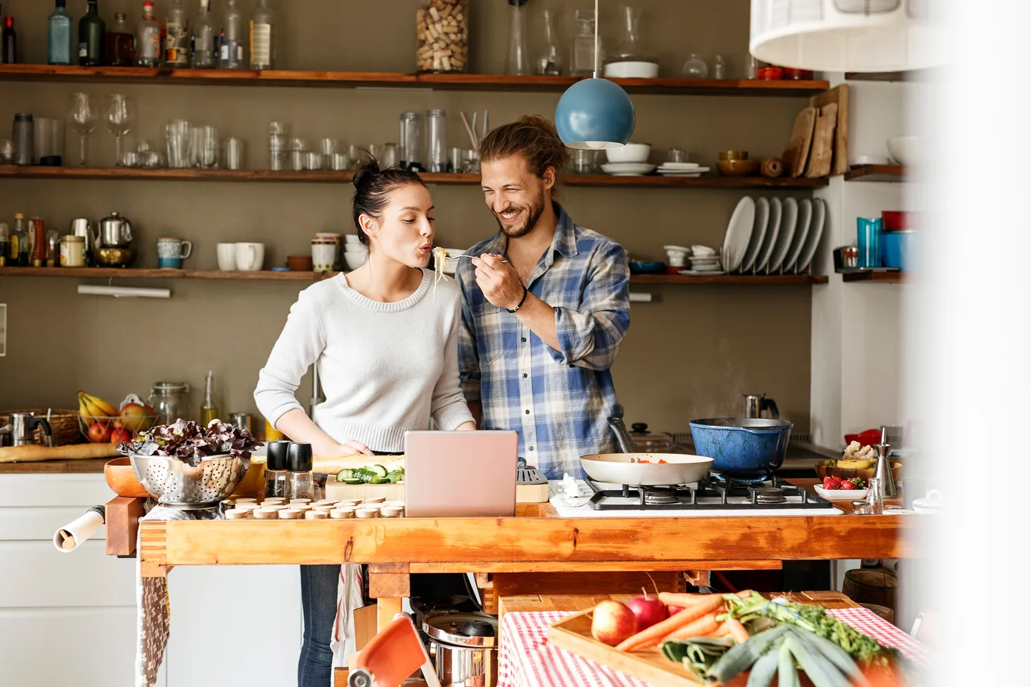 couple cooking in kitchen