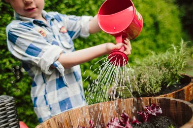 Kid watering garden