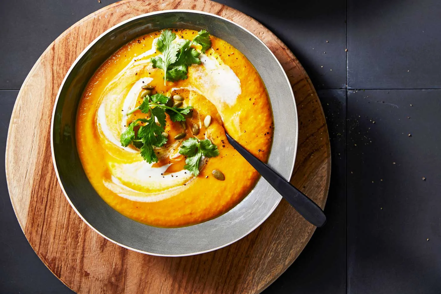 Roasted carrot and ginger soup with sour cream and pepitas