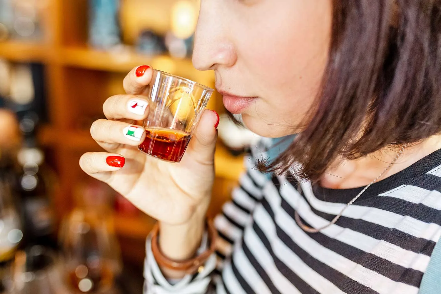 Woman tasting whisky