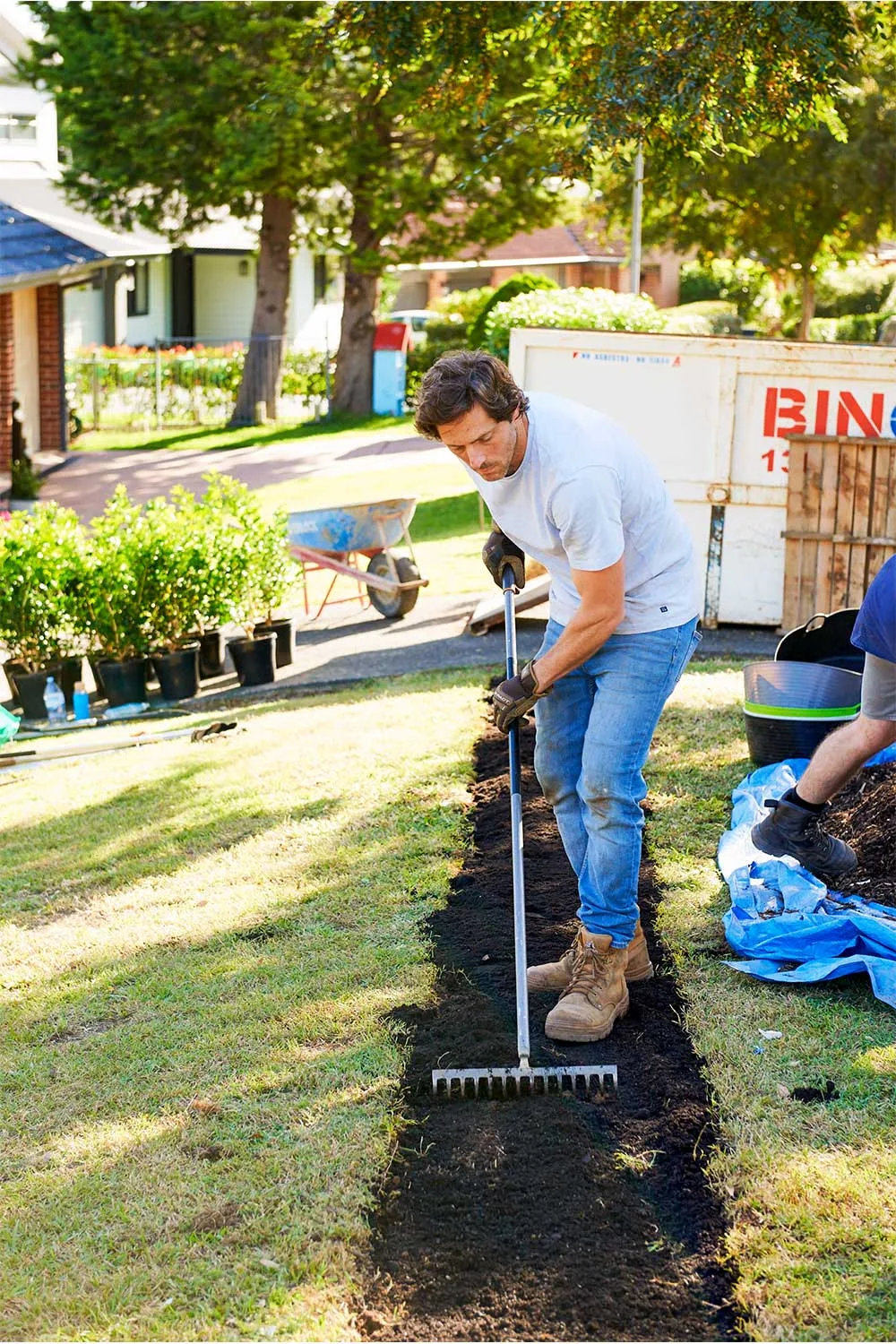 Charlie Albone raking soil