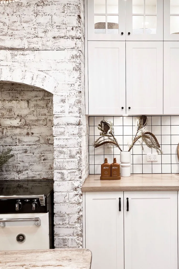 Renovated kitchen with inbuilt stove in fireplace