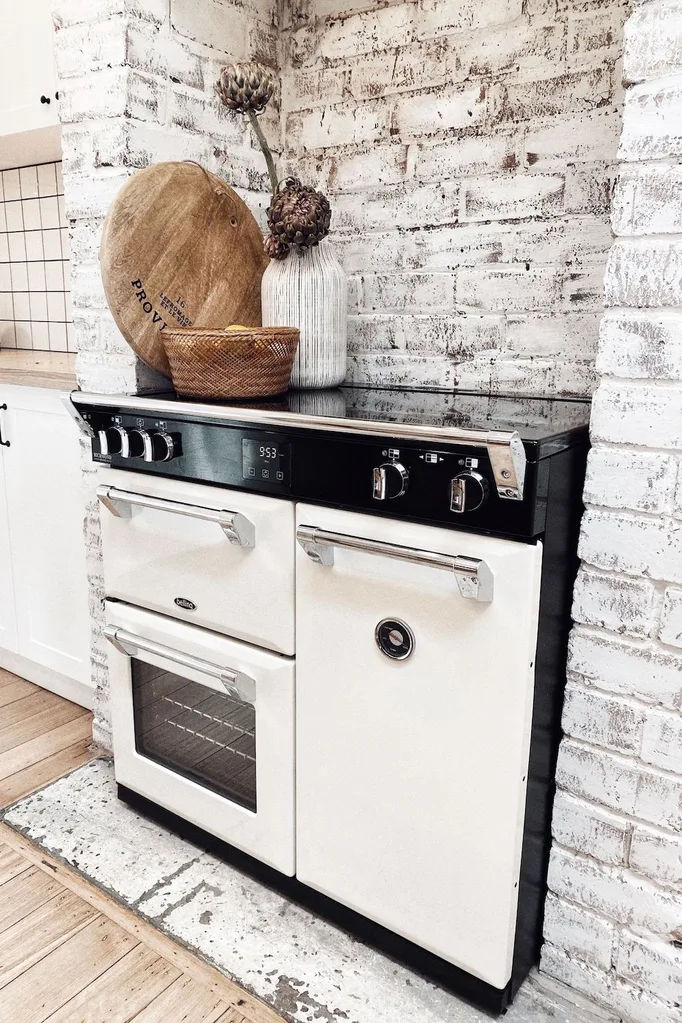 An oven fitted in an empty fireplace