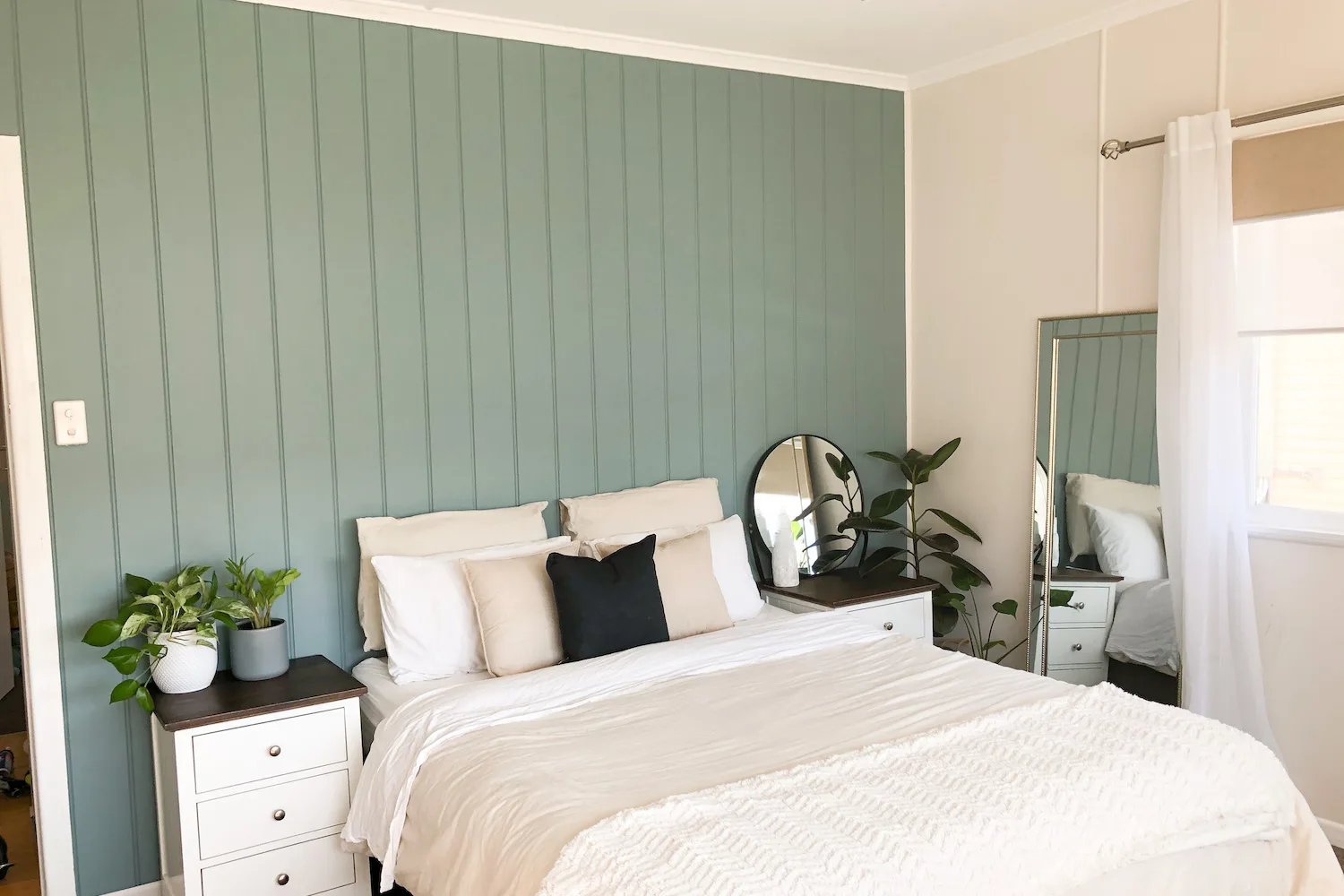 Pale green feature wall in bedroom