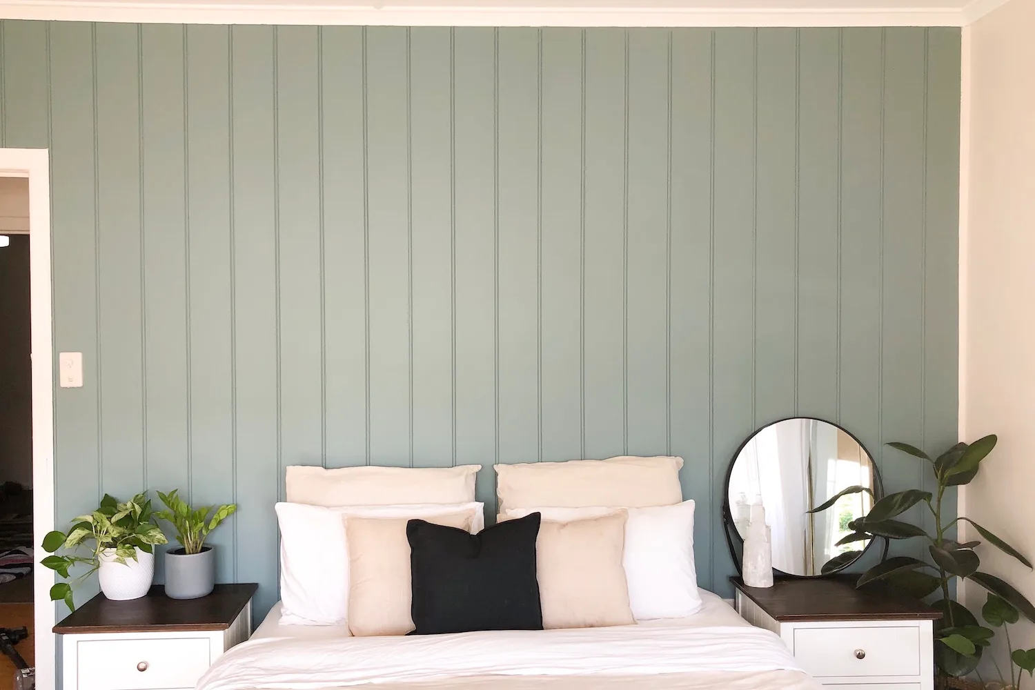 Pale green feature wall in bedroom