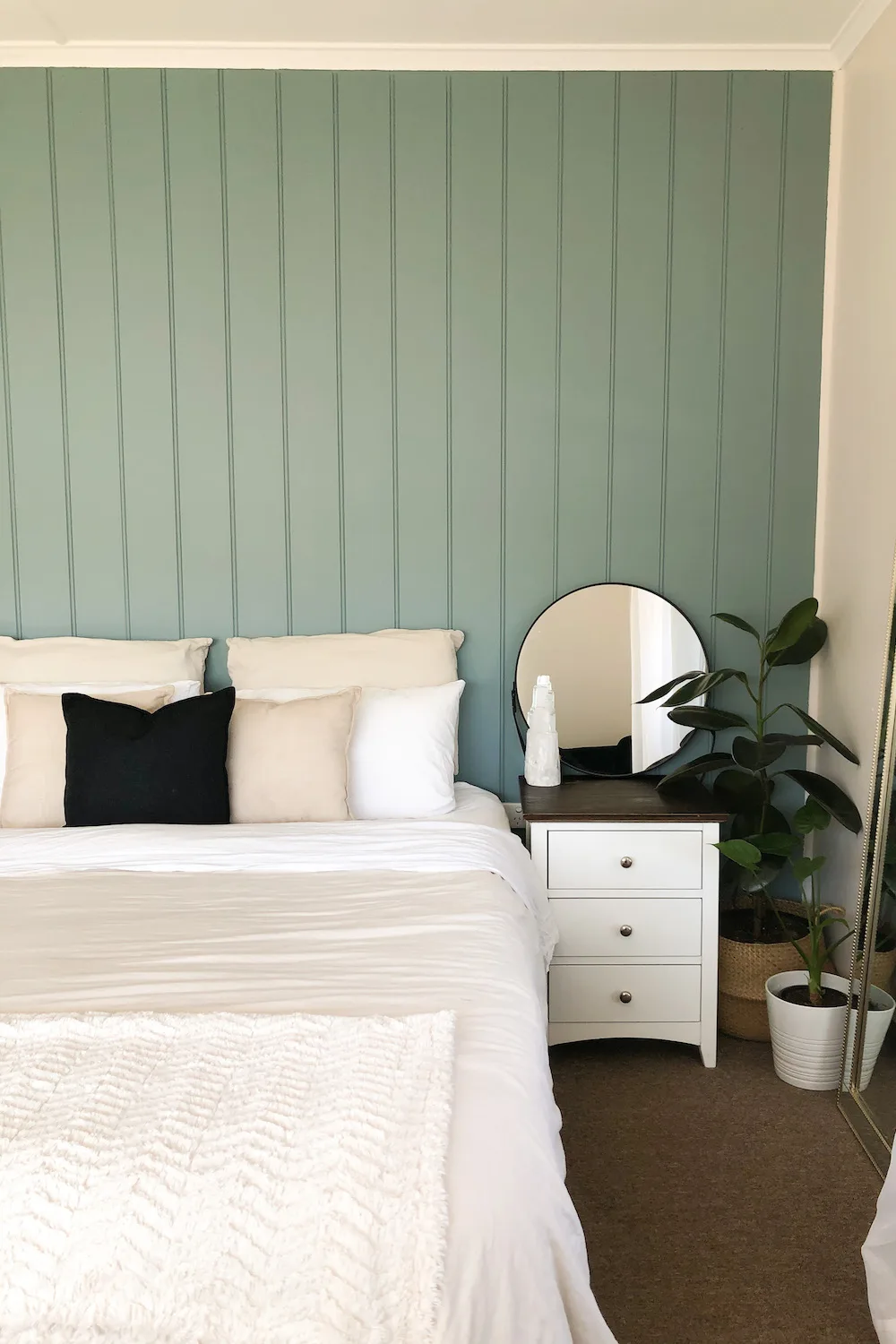 Pale green feature wall in bedroom