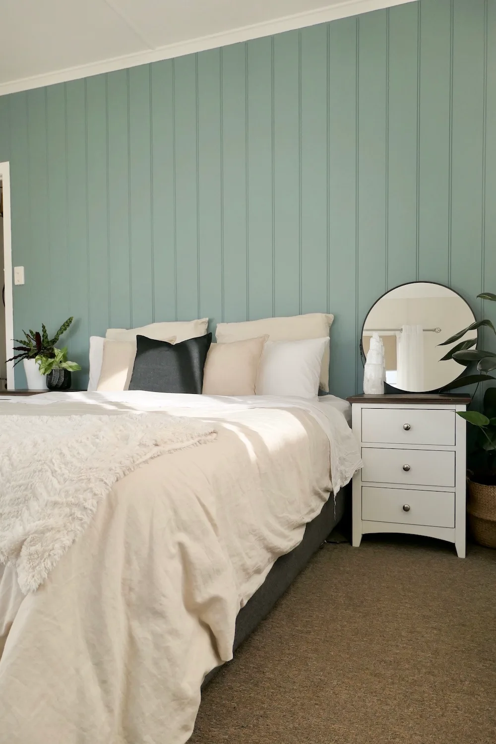 Bed in bedroom with feature wall