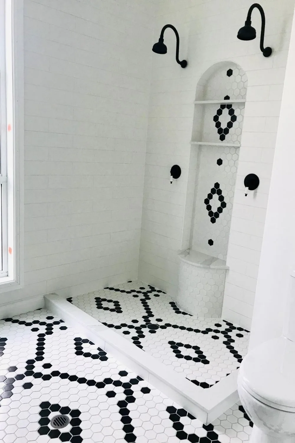 luxe bathroom renovation with black and white tiles