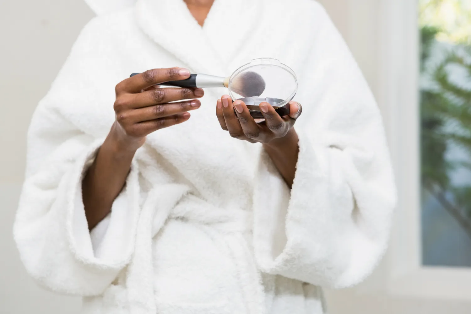 woman in robe with makeup
