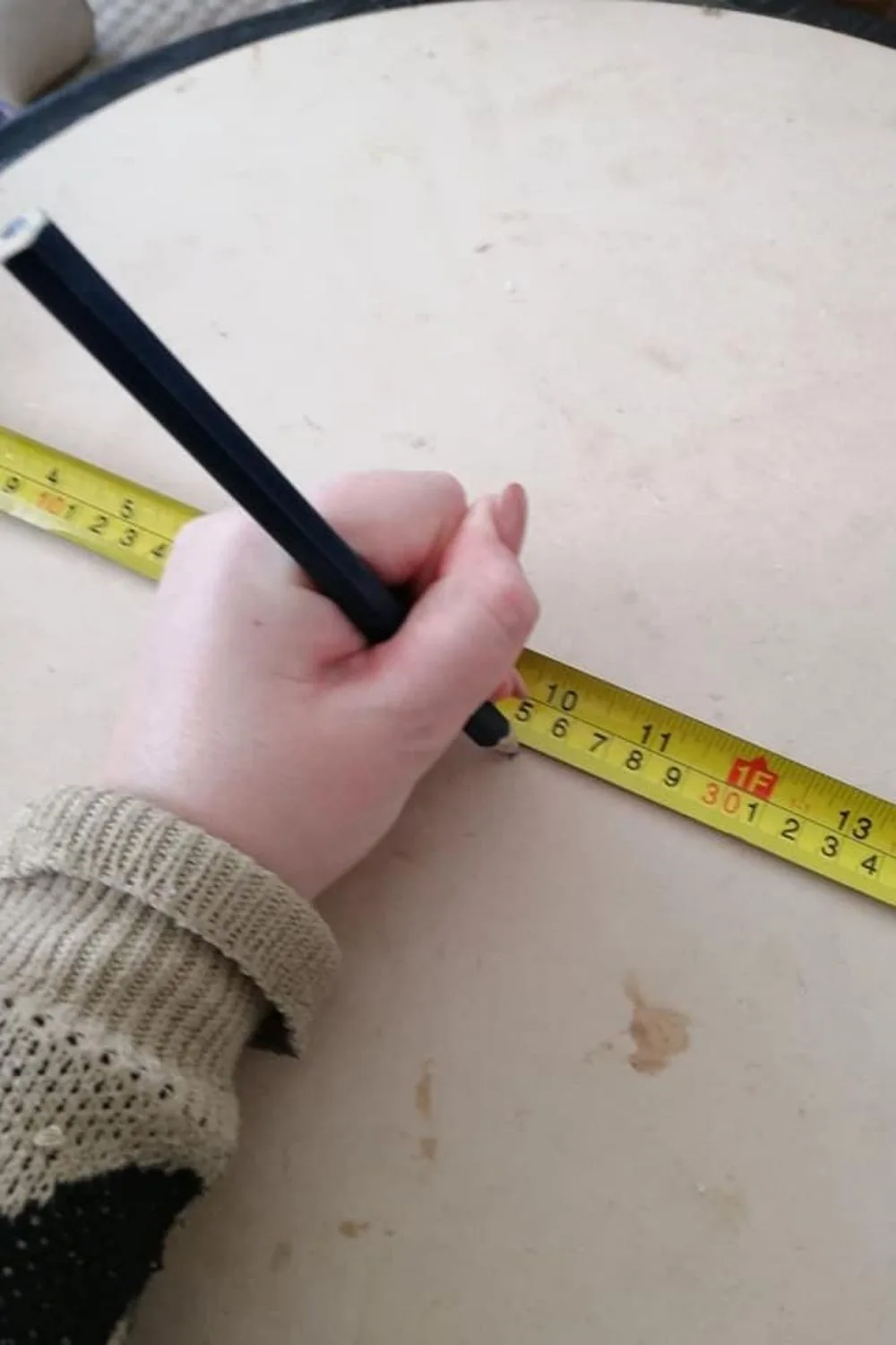 Measuring wood with tape