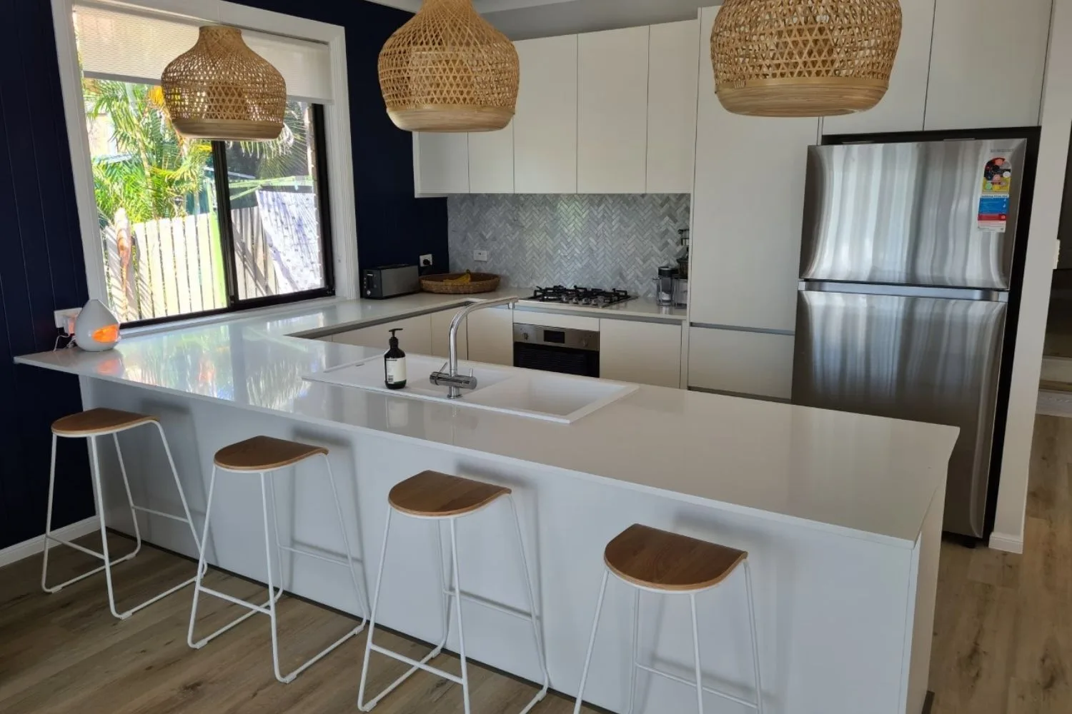after white and navy kitchen with floorboards