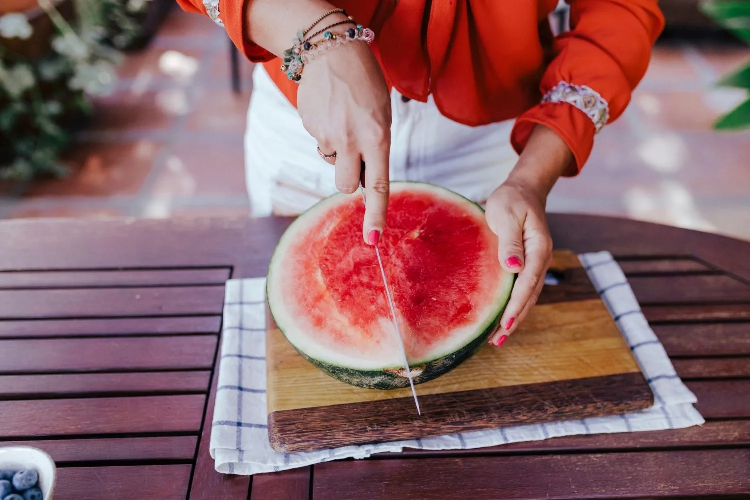 woman cutting watermelon