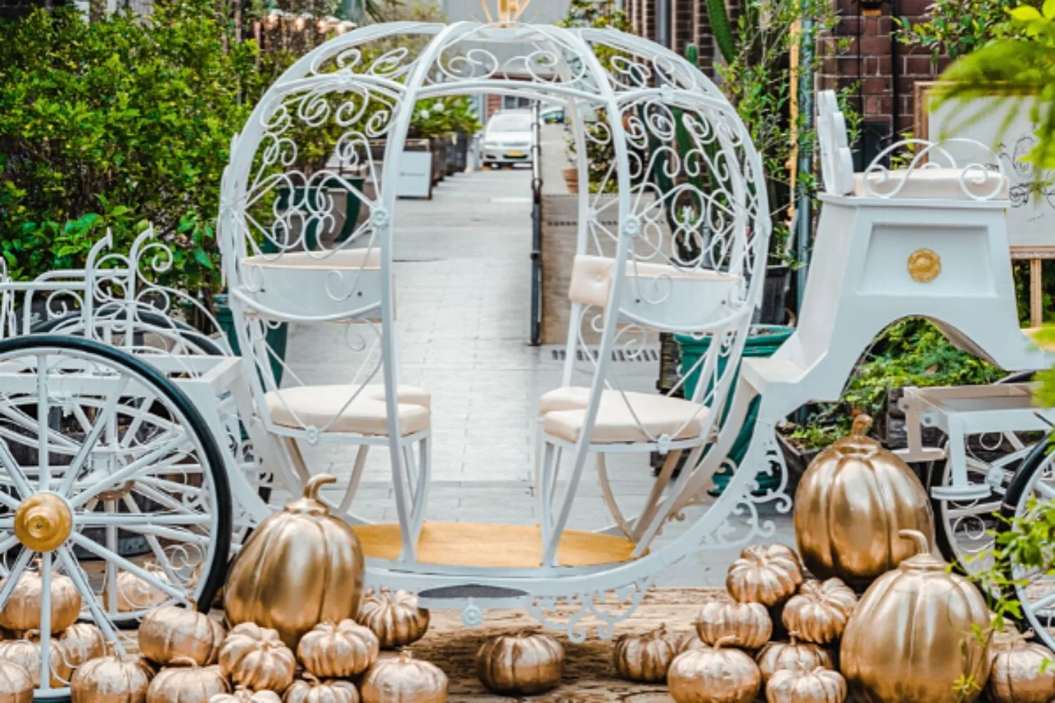 white carriage with gold pumpkins