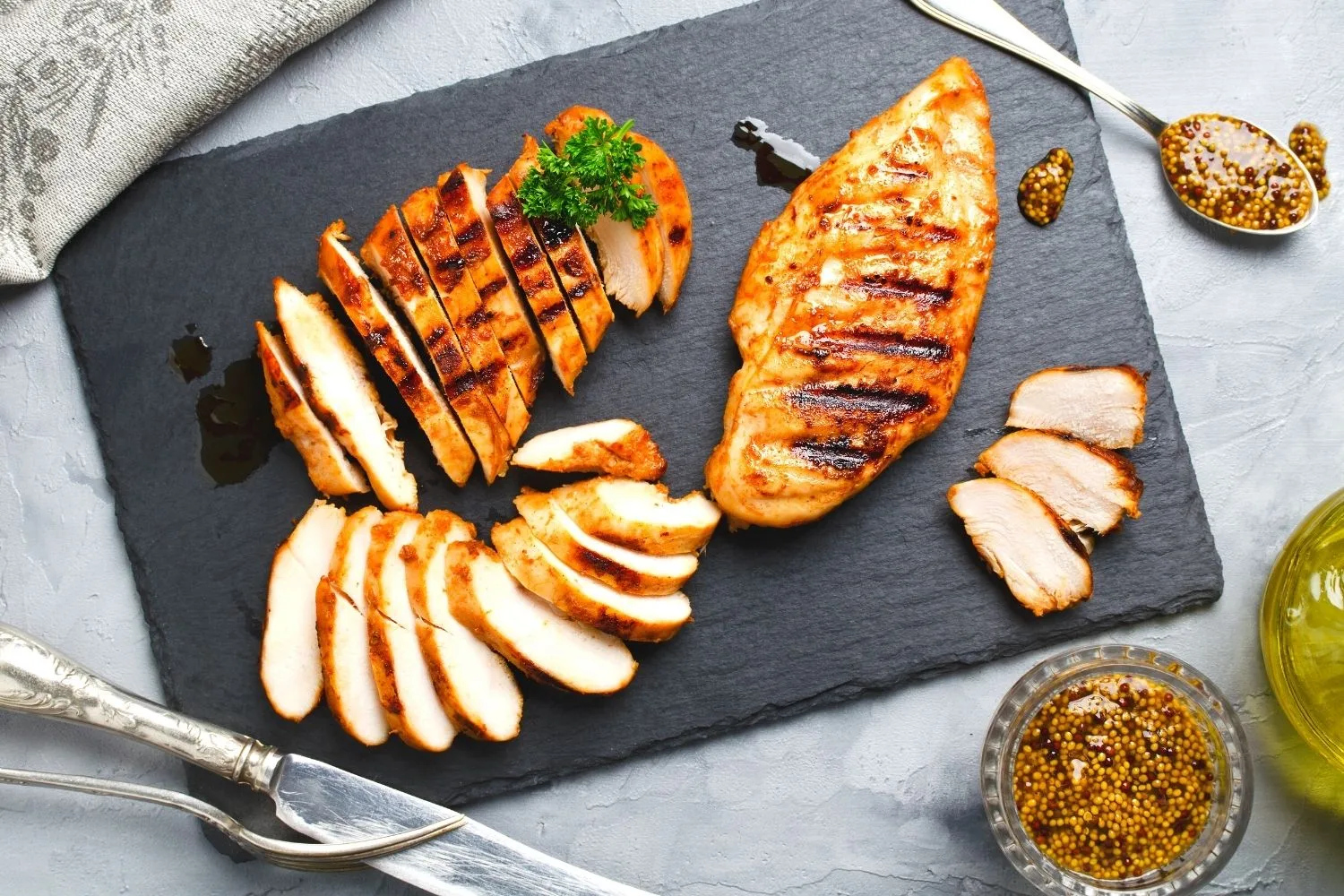 Grilled chicken breast on a cutting board