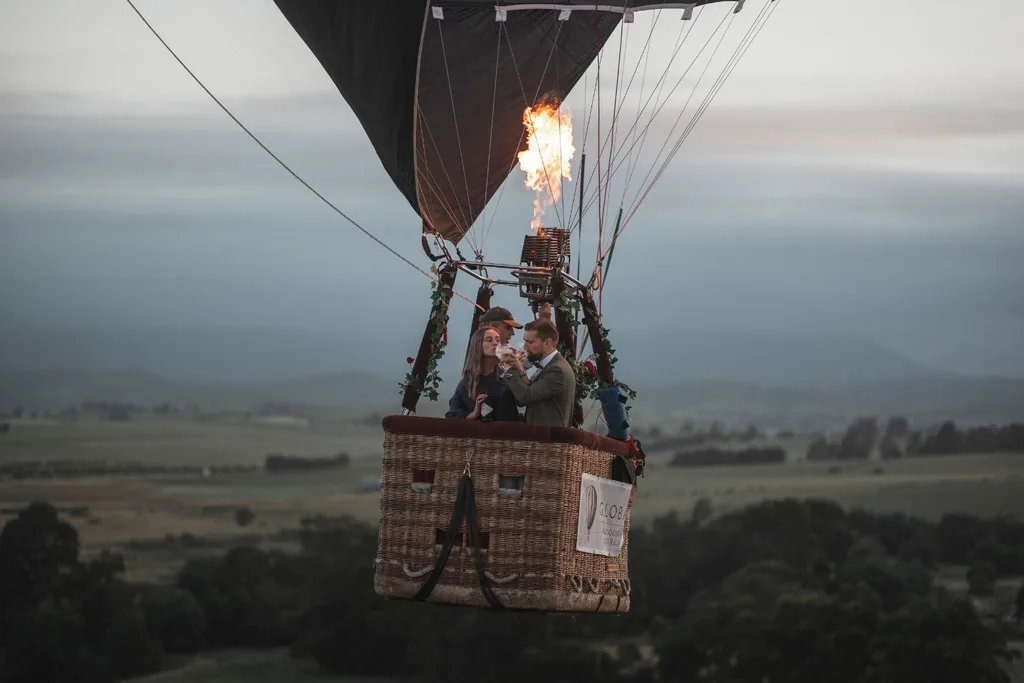balloon in the sky with two people toasting