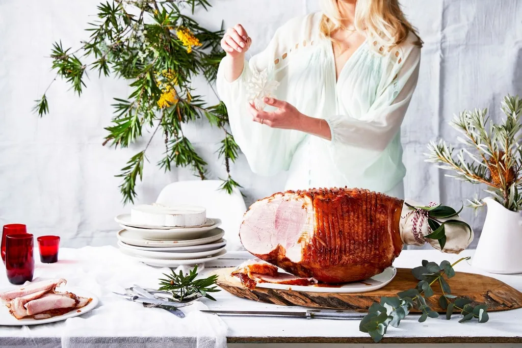 Fig glazed ham on a table decorated with Christmas ornaments