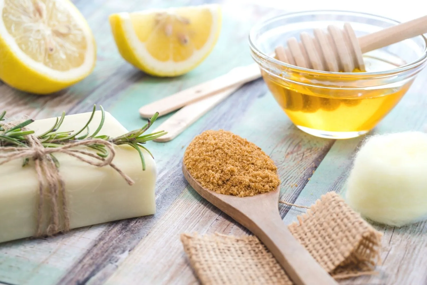 Brown sugar, honey and lemons on a table
