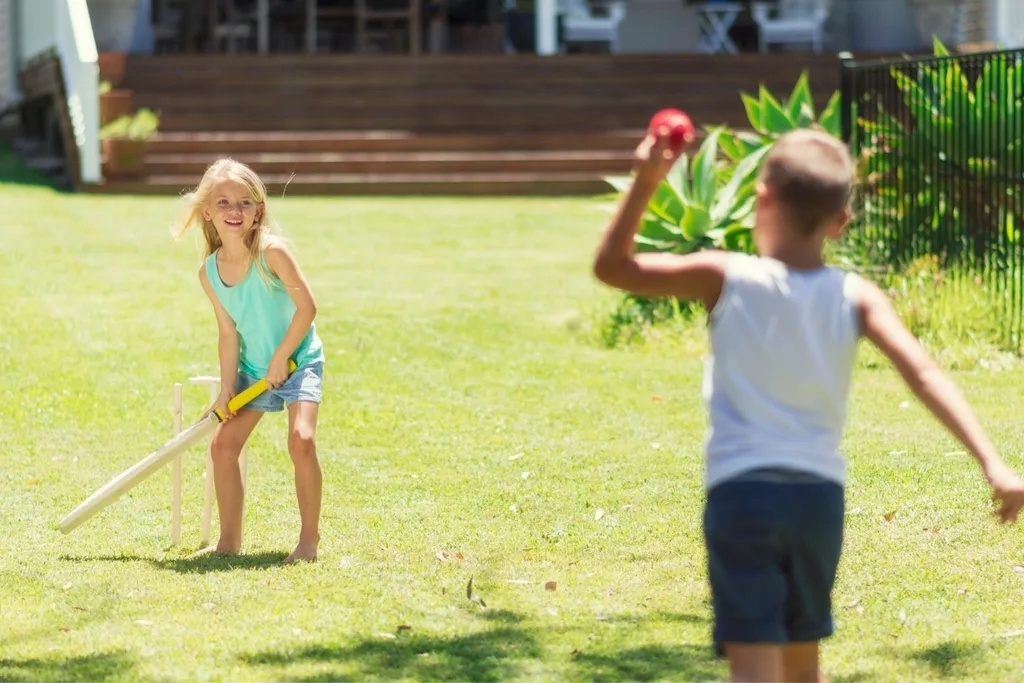 two kids playing cricket