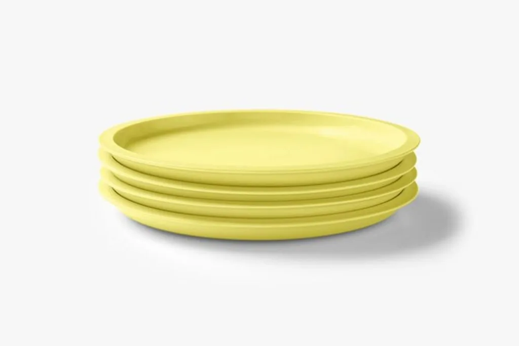 Stack of four yellow plates