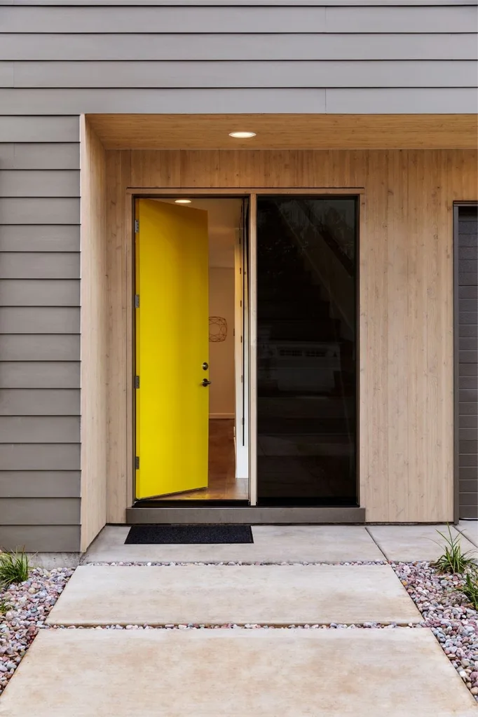 Grey house with a yellow front door