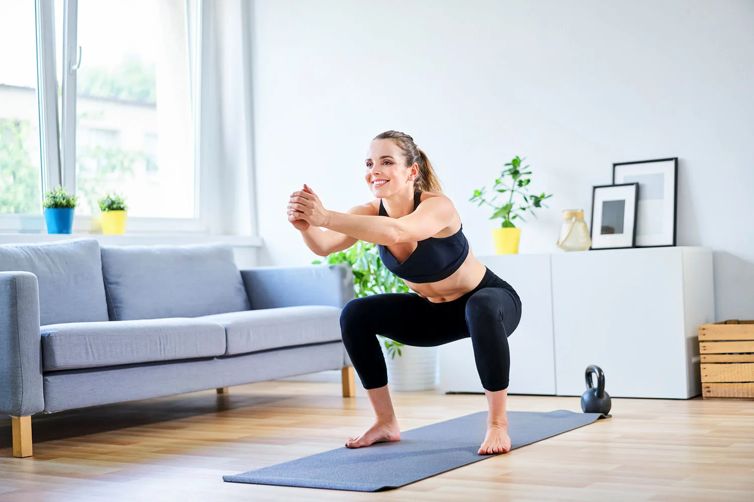 Woman doing a home workout in a living room