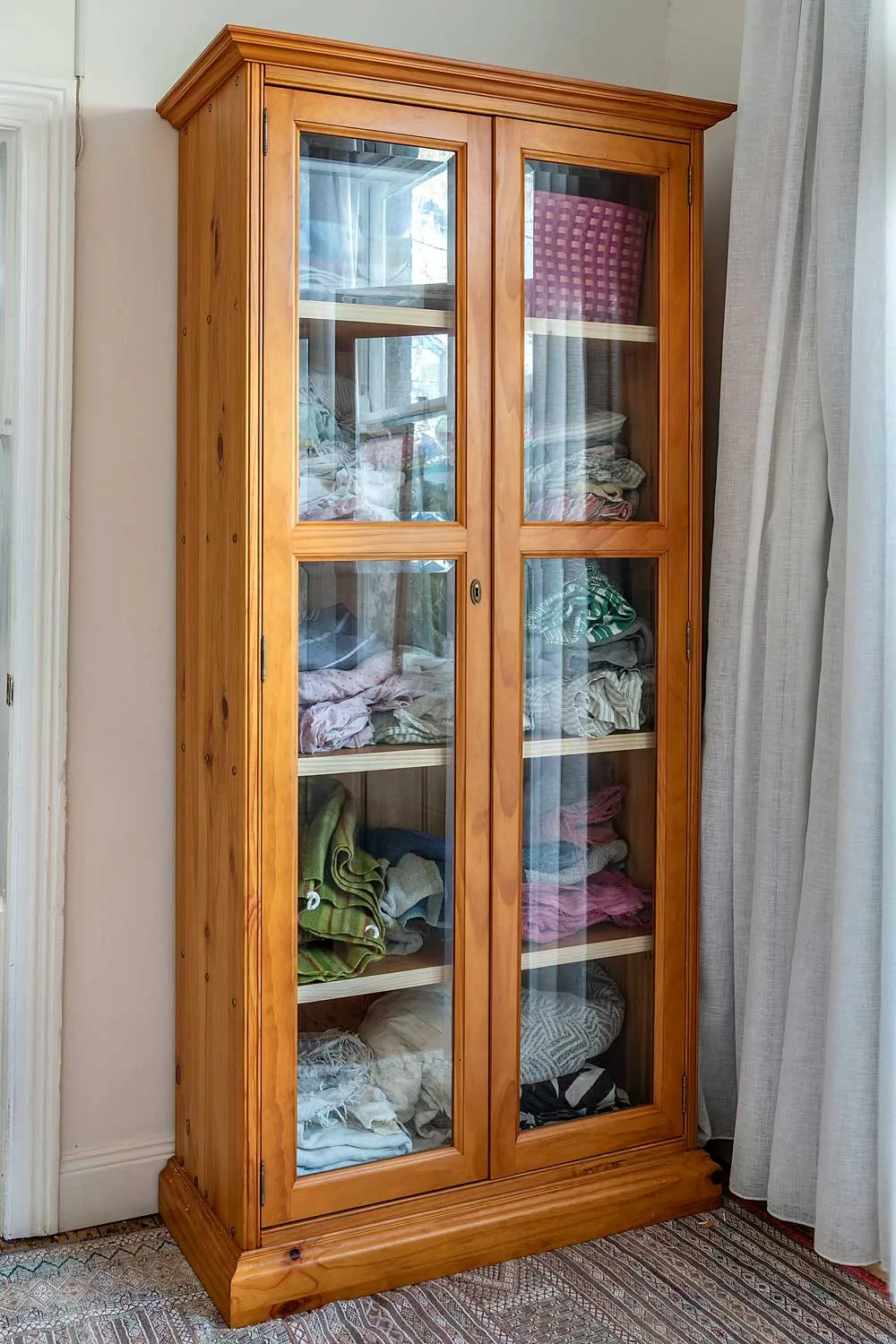 timber cabinet with glass paned doors