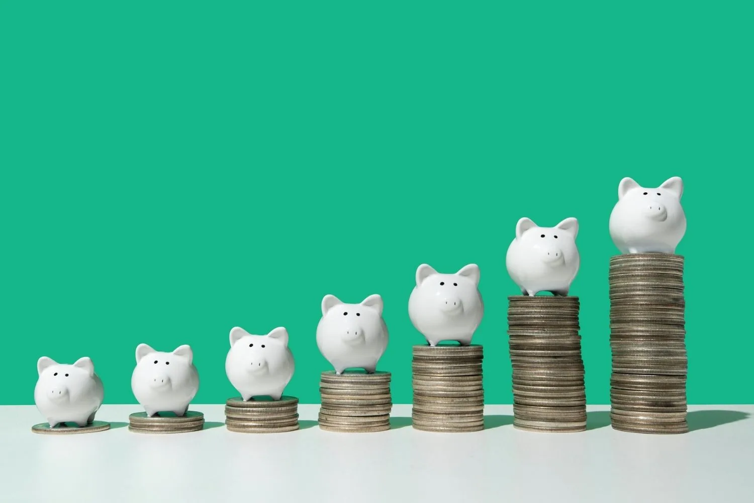 little pigs sitting on coin towers