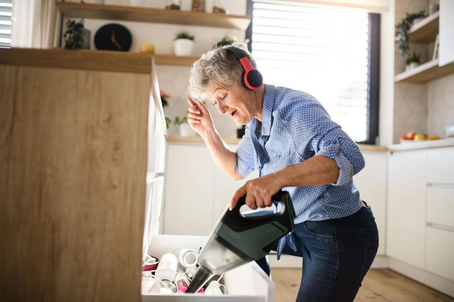 woman listening to music and cleaning