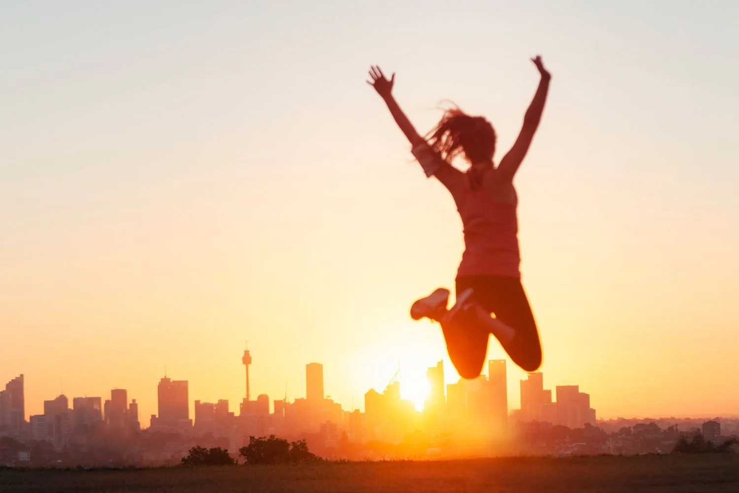 woman jumping in sunlight