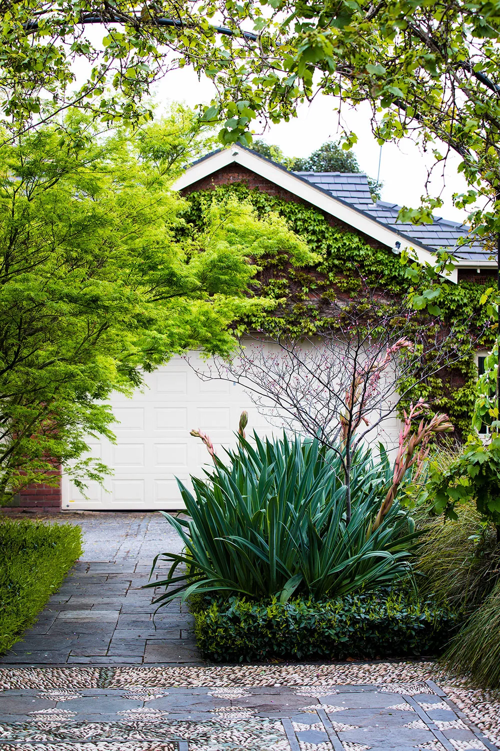 Pavings laid in a pattern in front of a garage door
