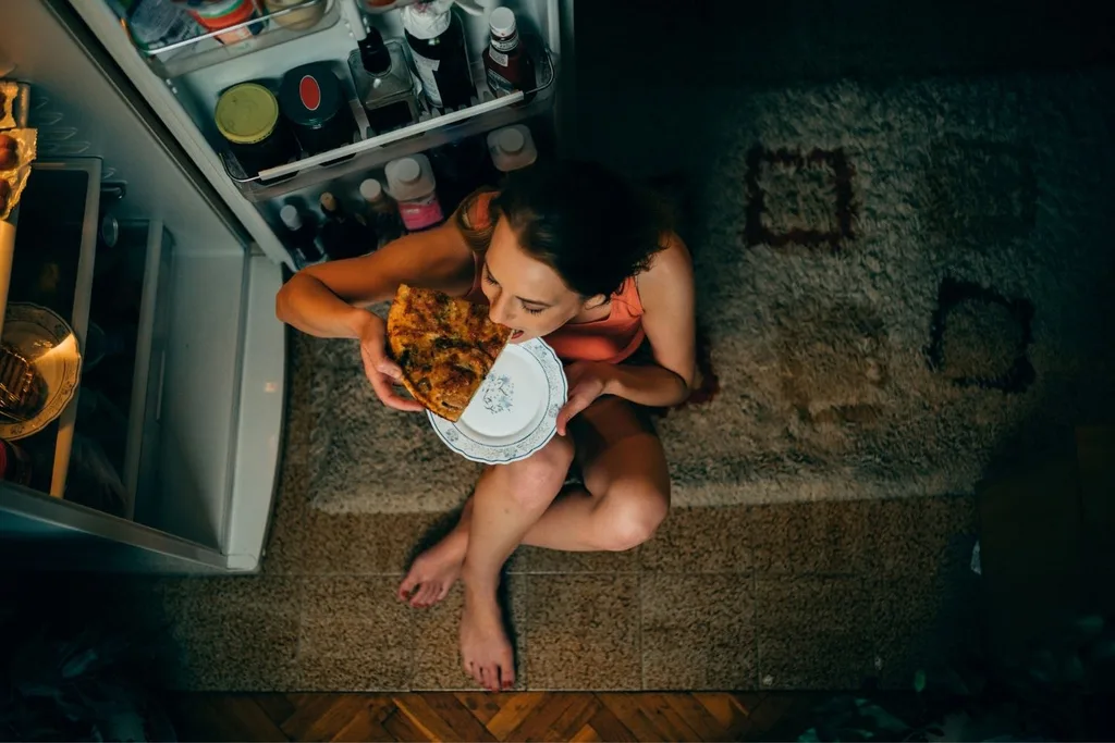 woman eating pizza