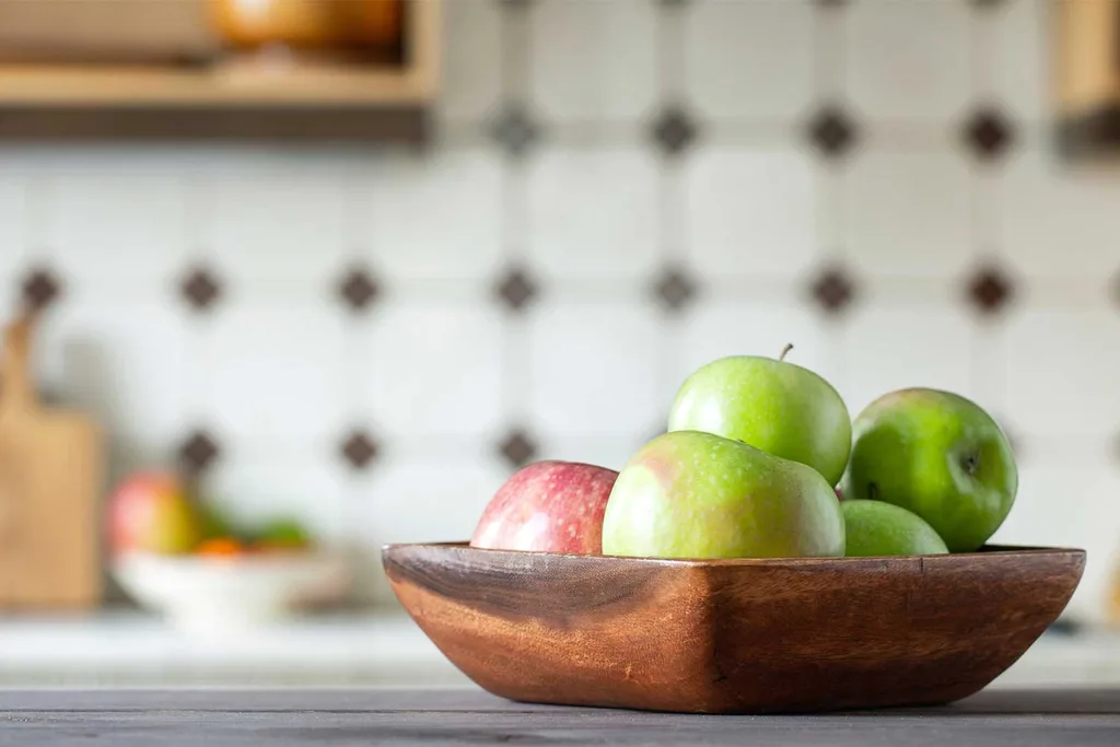 Bowl of fruit sitting on a kitchen bench