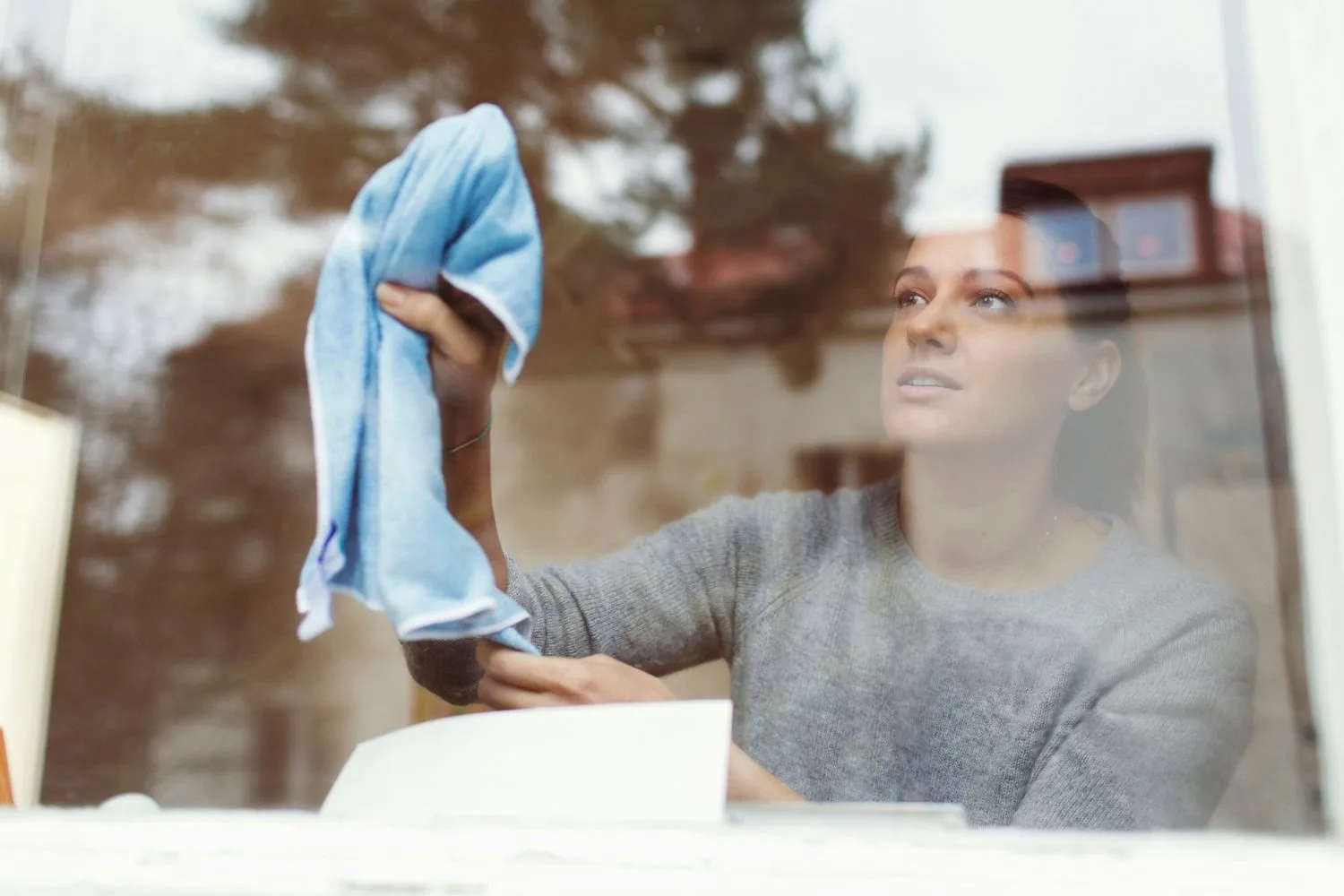 woman cleaning window