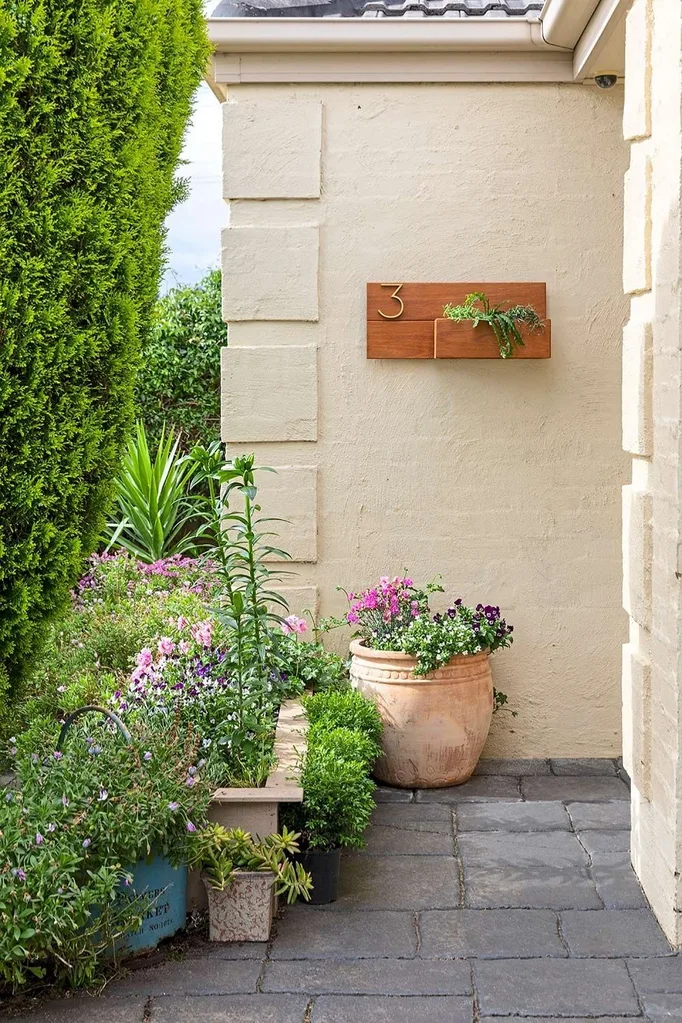 Cream coloured house with a timber planter hung on the wall