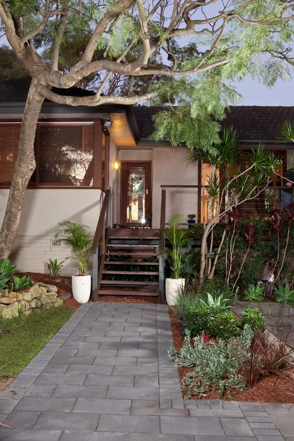 A paved front pathway leads the the door of a house