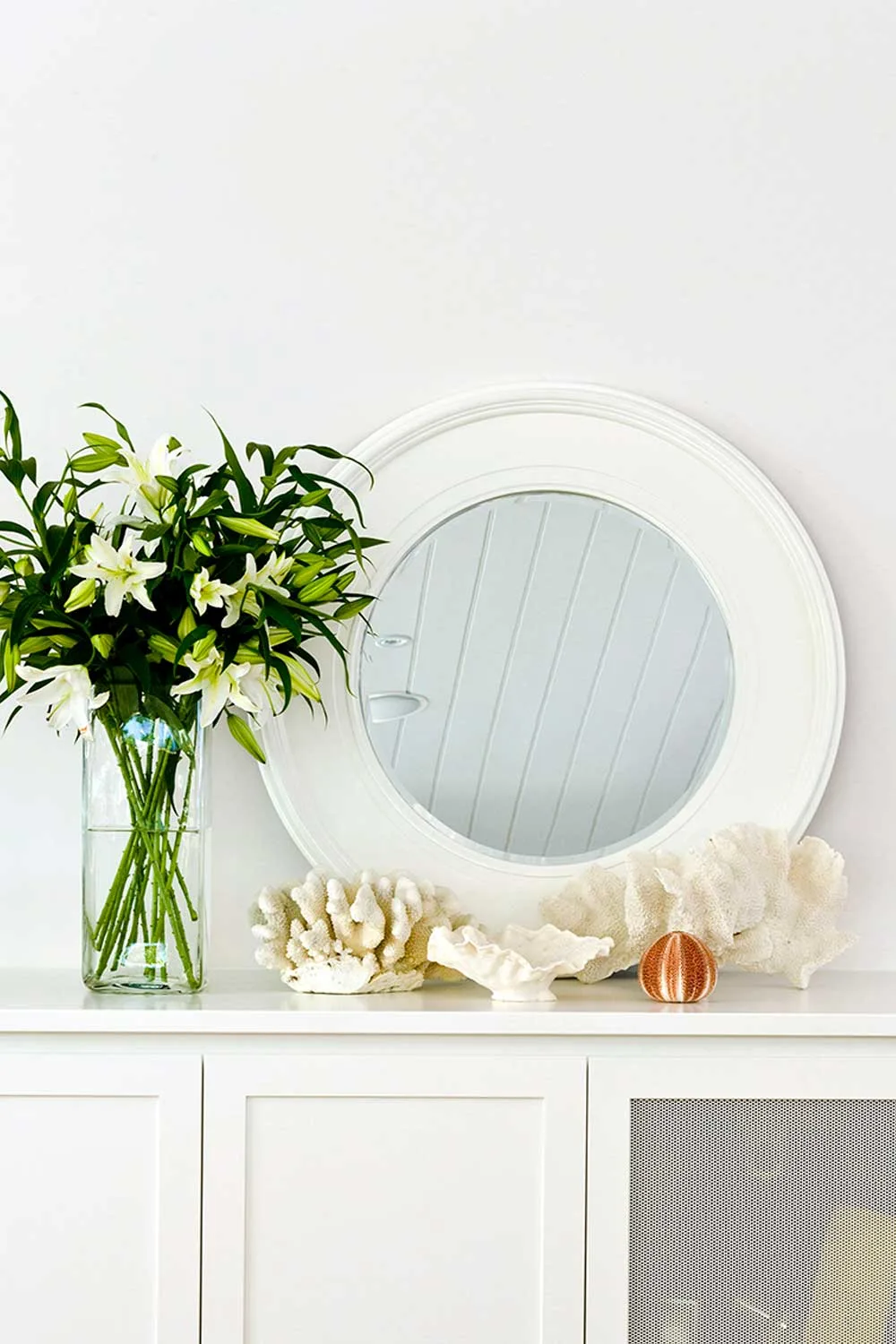 Coral homewares on top of a sideboard