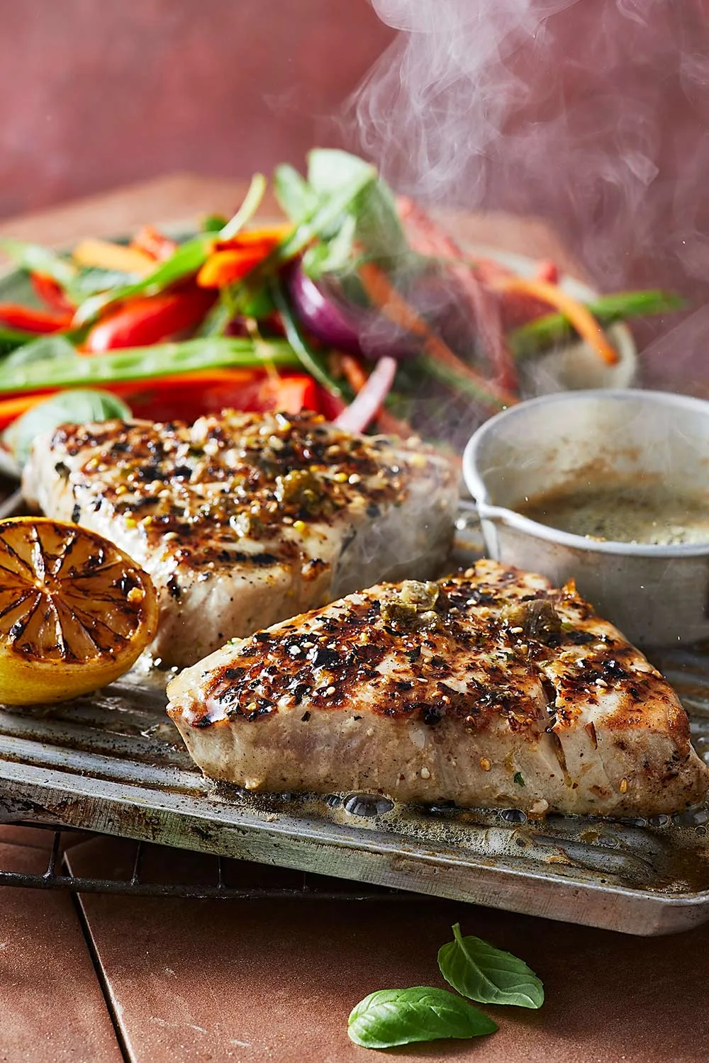 Seared yellowfin tuna on a tray steaming just off the grill